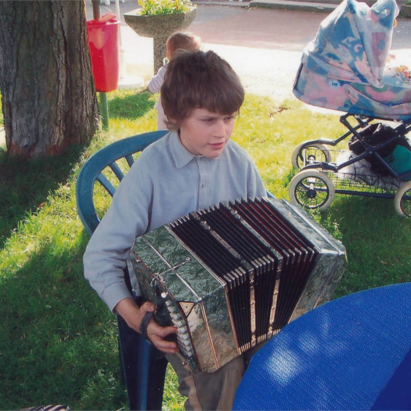 Young Valentin playing the bandoneon during childhood