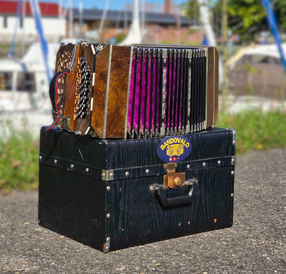 Front view of Valentin's bandoneon, showing the wooden finish, buttons, and bellows structure