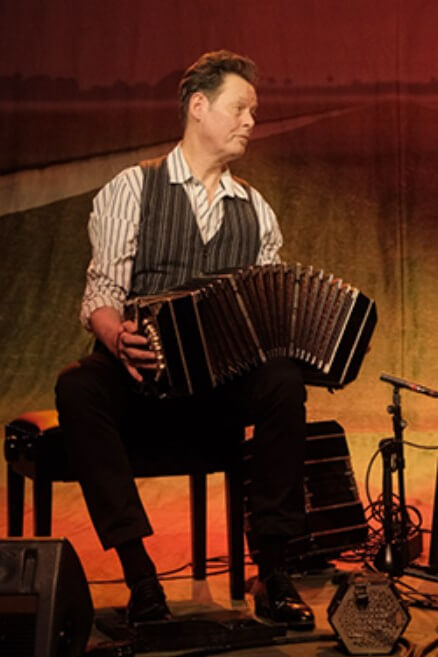 Dutch bandoneonist Carel Kraayenhof playing live, symbolizing the instrument's influence across Europe