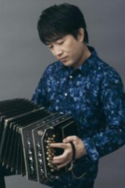 Japanese bandoneon artist Ryota Komatsu performing on stage, representing the global spread of the instrument