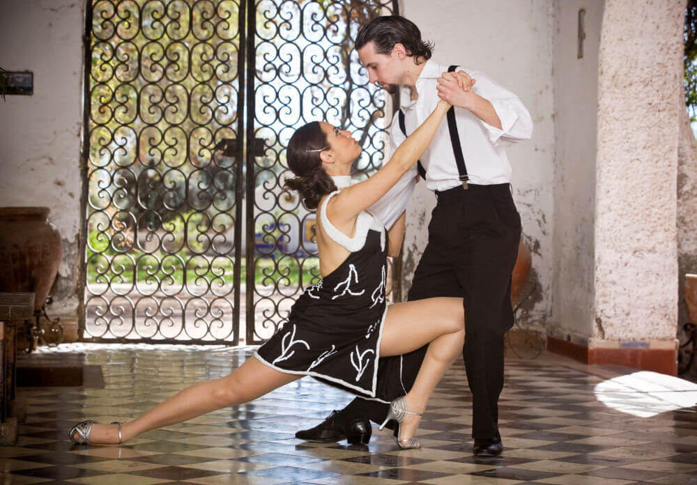 Man and woman dancing tango in the streets of Buenos Aires, expressing the passion and rhythm of Argentine culture